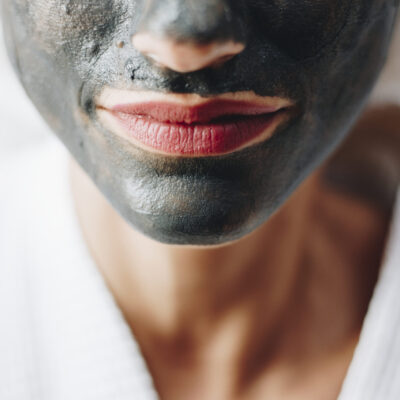 Woman relaxing with a charcoal facial mask